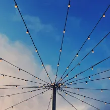 Strings of lightbulbs hung from a central pole 