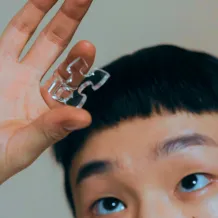 Young man looking at a puzzle piece