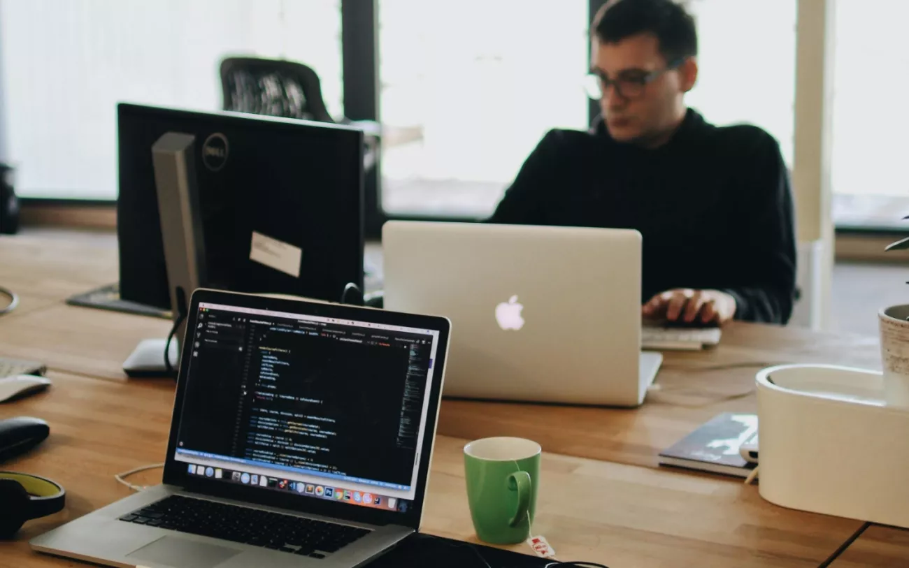 Male coworker at desk with computers