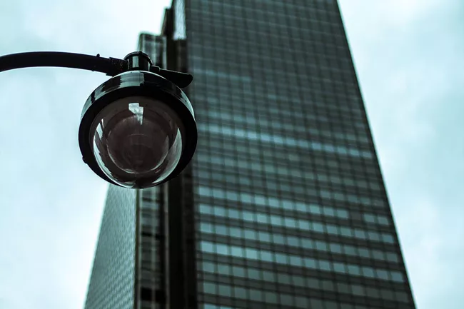 Security camera in front of a skyscraper