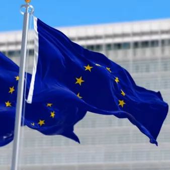 Banner background - EU flag waving in front of EU Headquarters